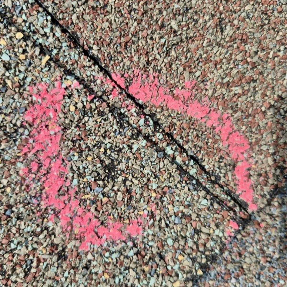Hail damage marked with chalk on shingle