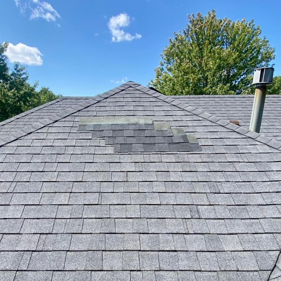 Storm-damaged roof with missing shingles